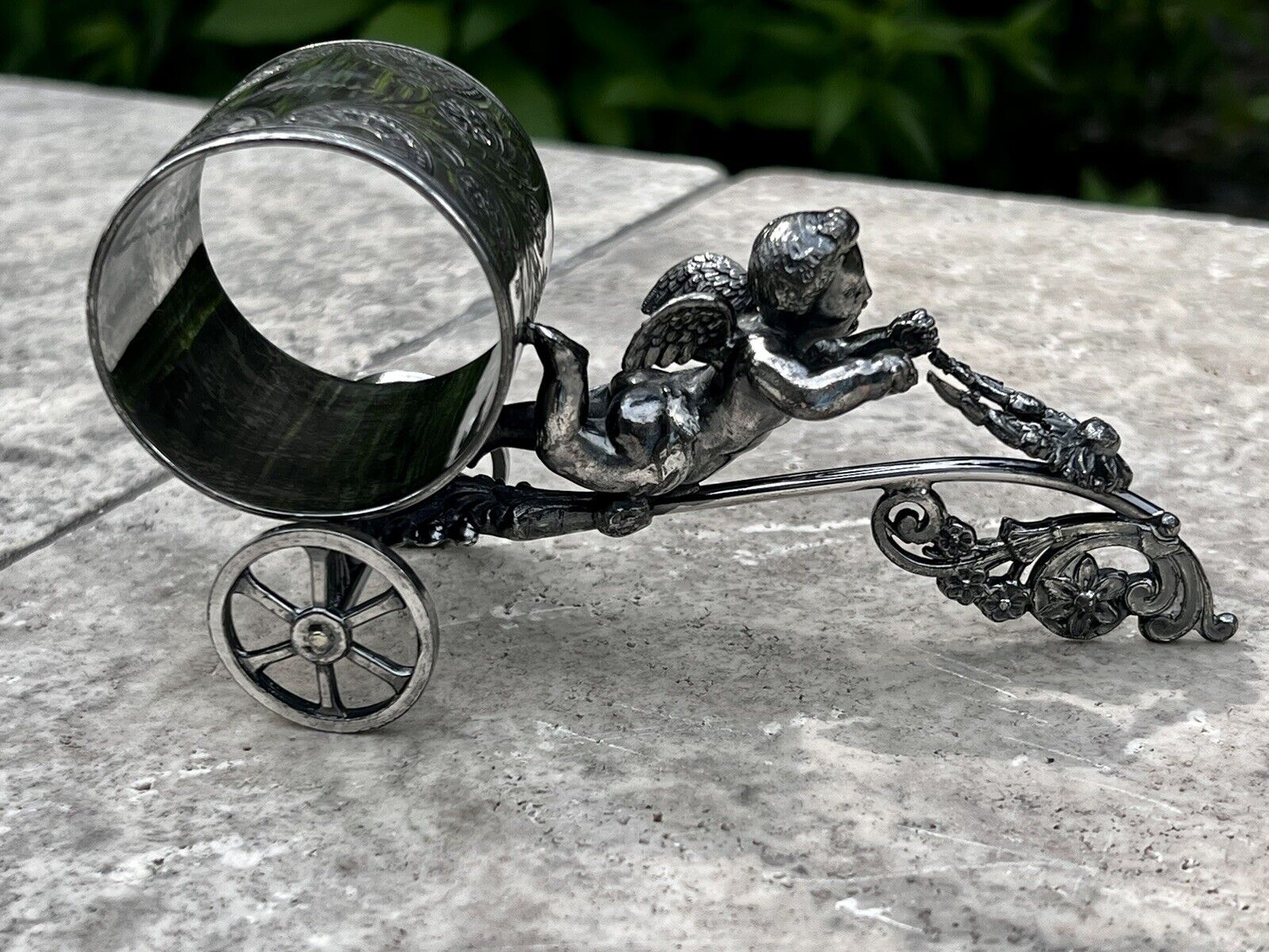 cherub flying on wheels no maker marked. number 86 or 98. One in G&W not numbered even.